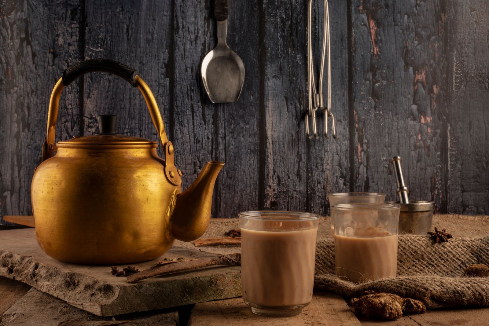 Brass kettle and glasses of masala chai