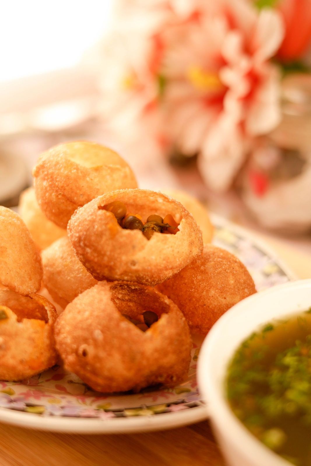 Pani puri on a plate with green chutney